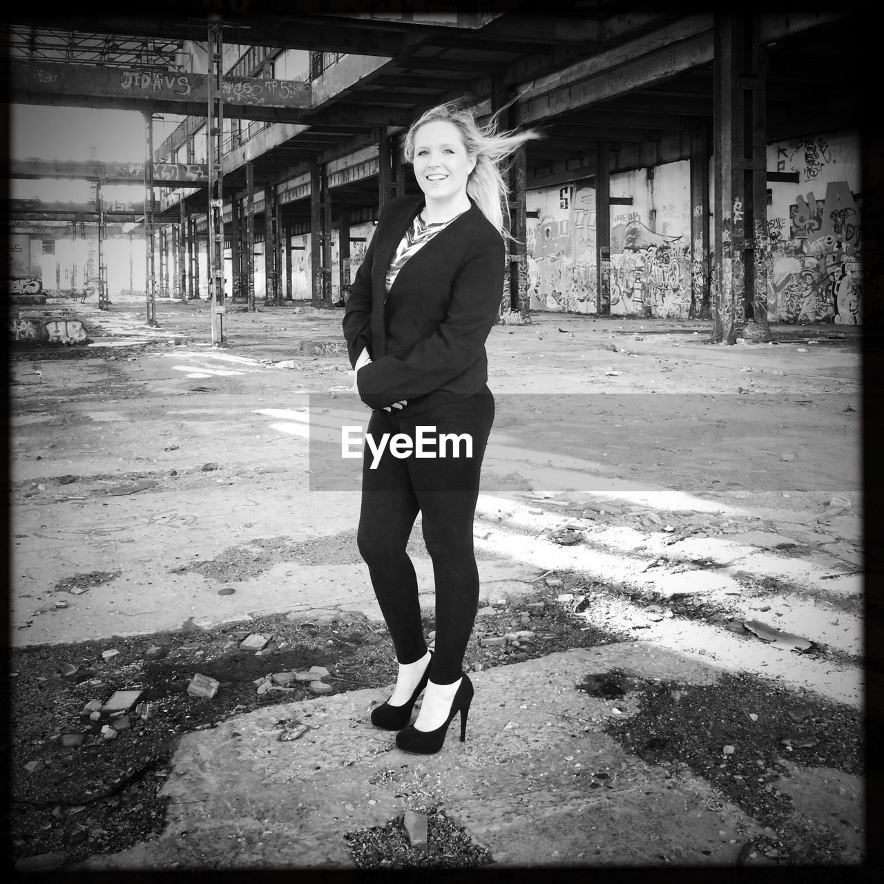 FULL LENGTH OF YOUNG WOMAN STANDING ON RAILING