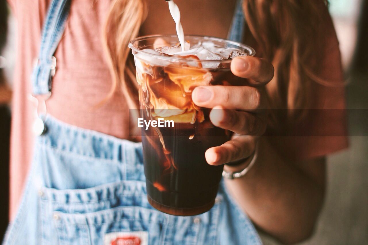 Woman making iced coffee