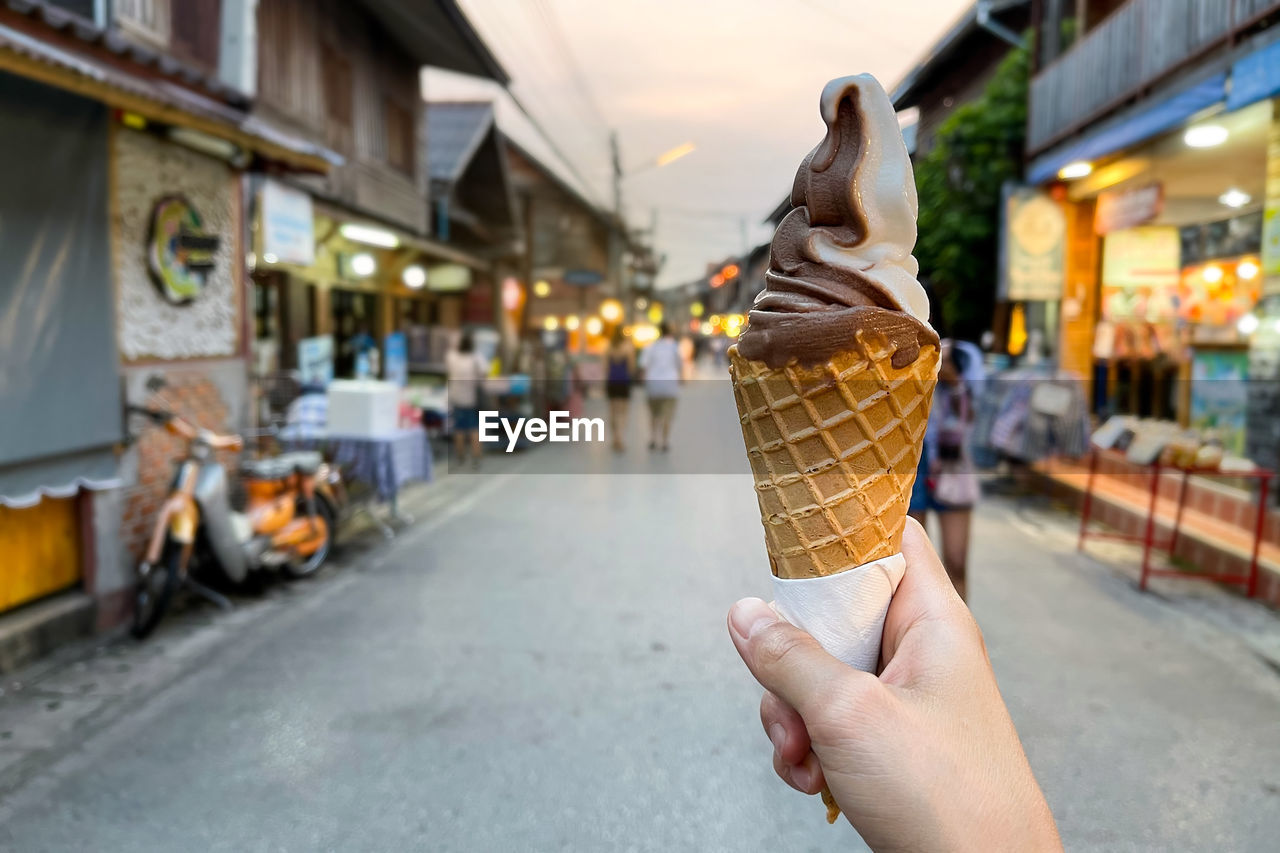 Female hand holding chocolate ice cream