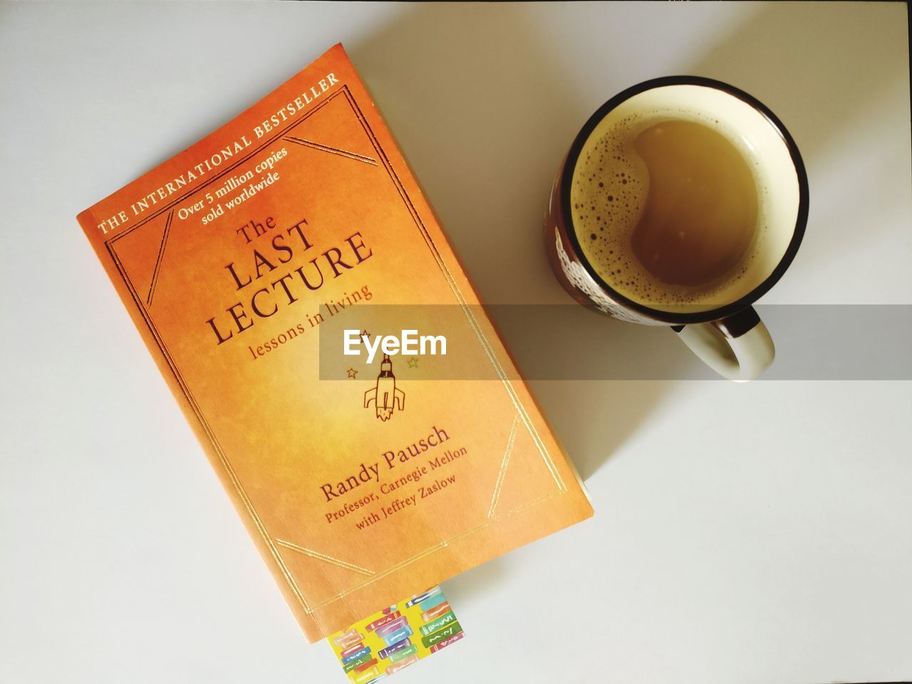 HIGH ANGLE VIEW OF COFFEE CUP WITH TEXT ON TABLE