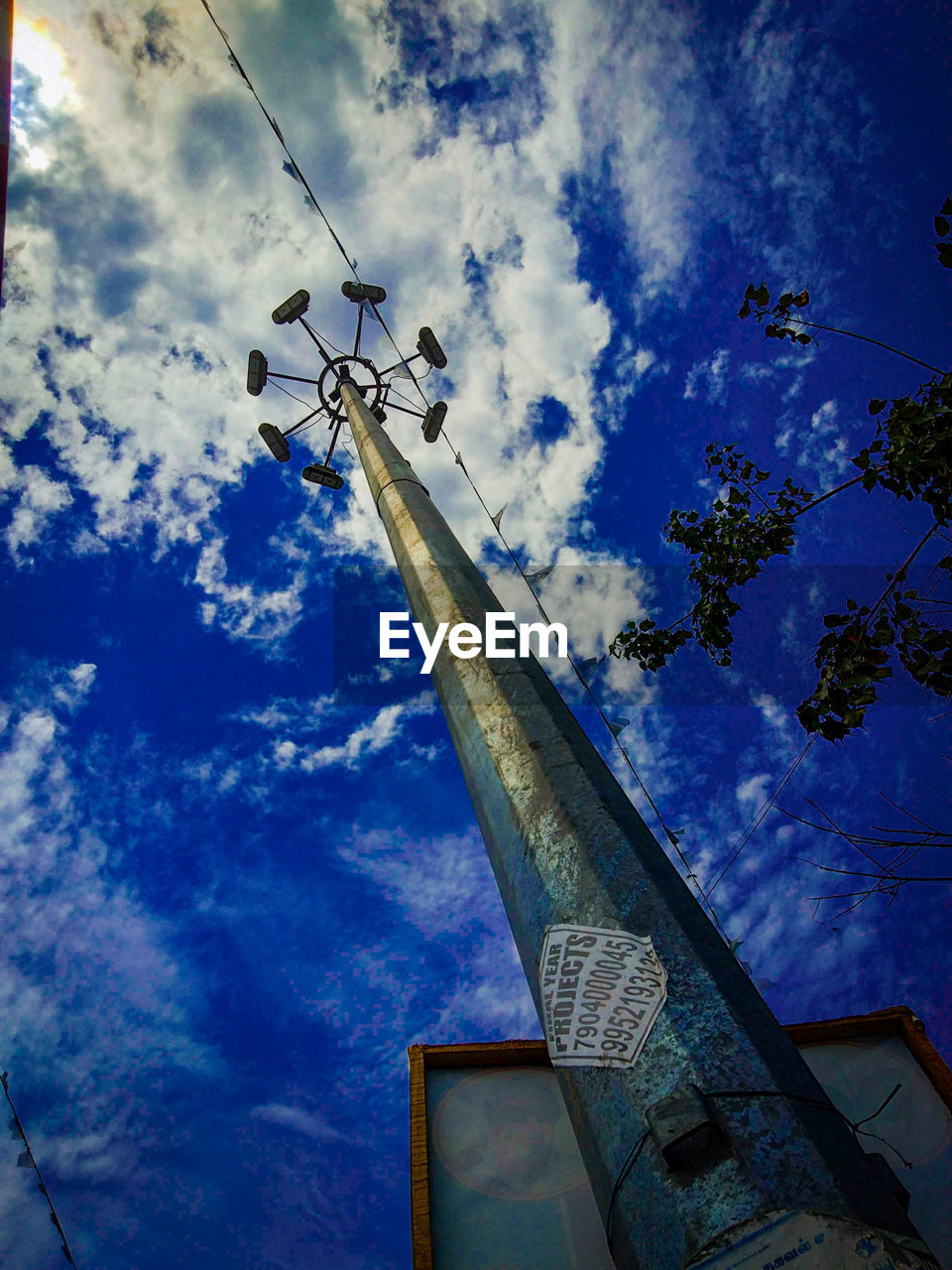 LOW ANGLE VIEW OF COMMUNICATIONS TOWER AGAINST BLUE SKY