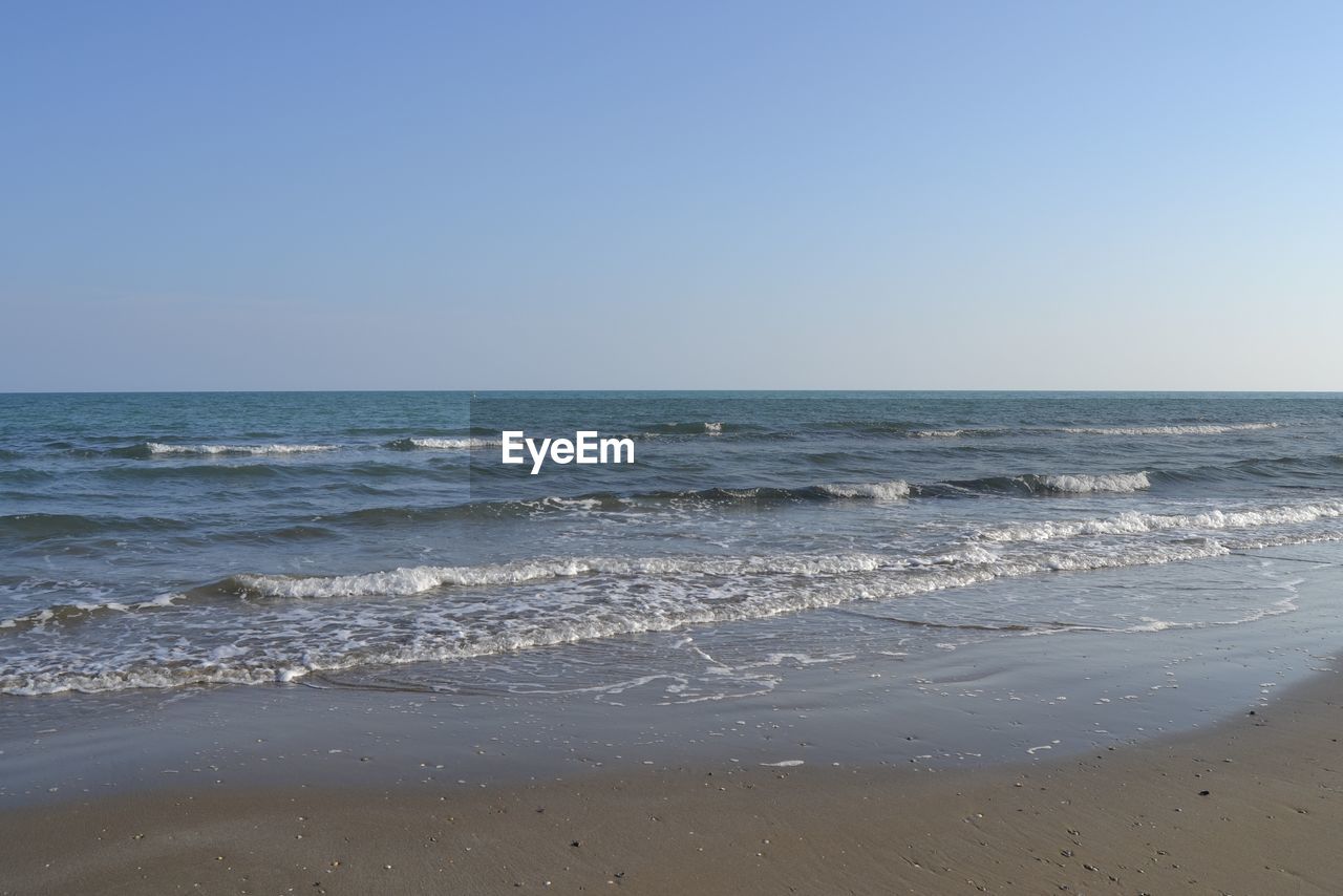 SCENIC VIEW OF SEA AGAINST CLEAR SKY AT BEACH