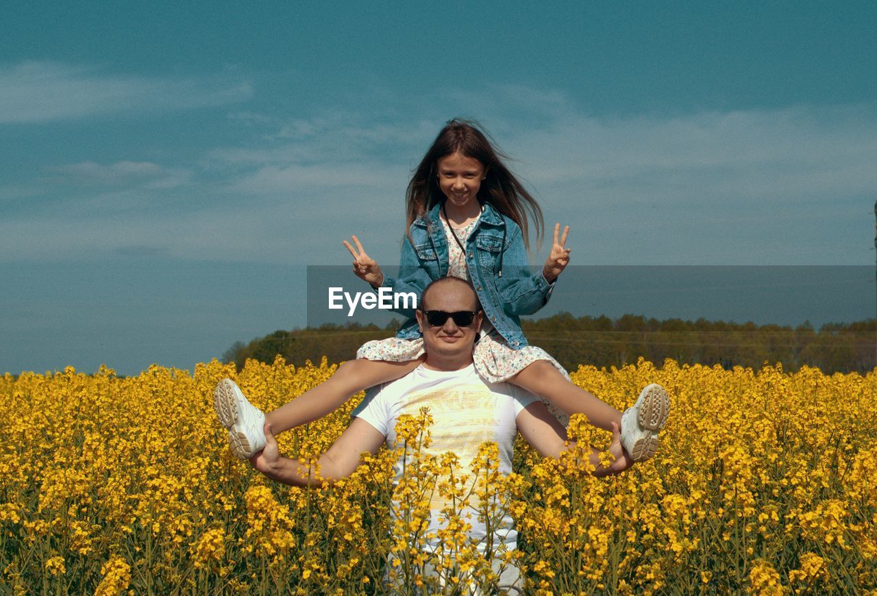 Portrait of dad with daughter on shoulders