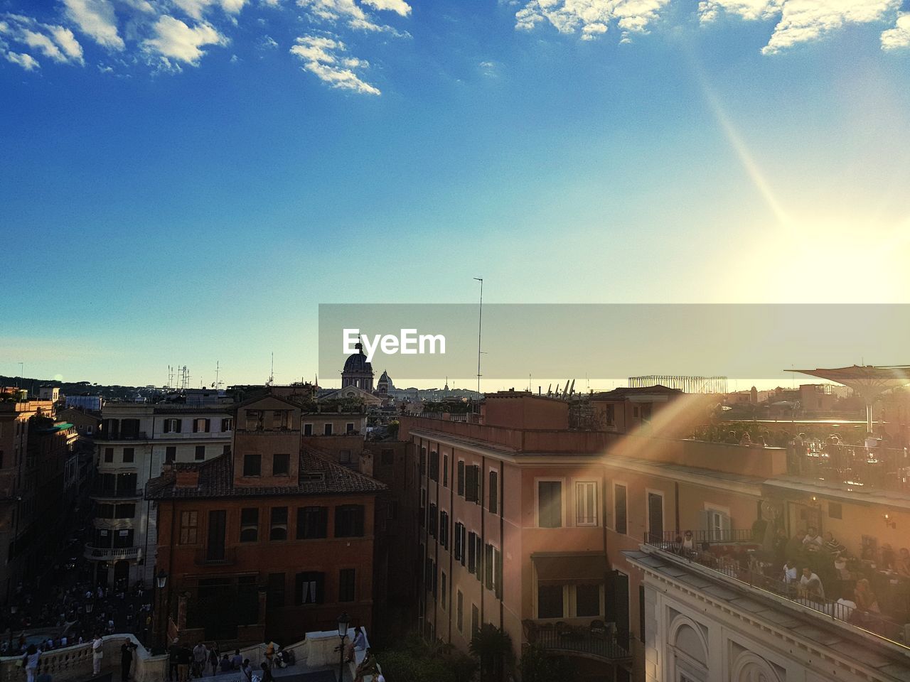 View of town against sky at sunset