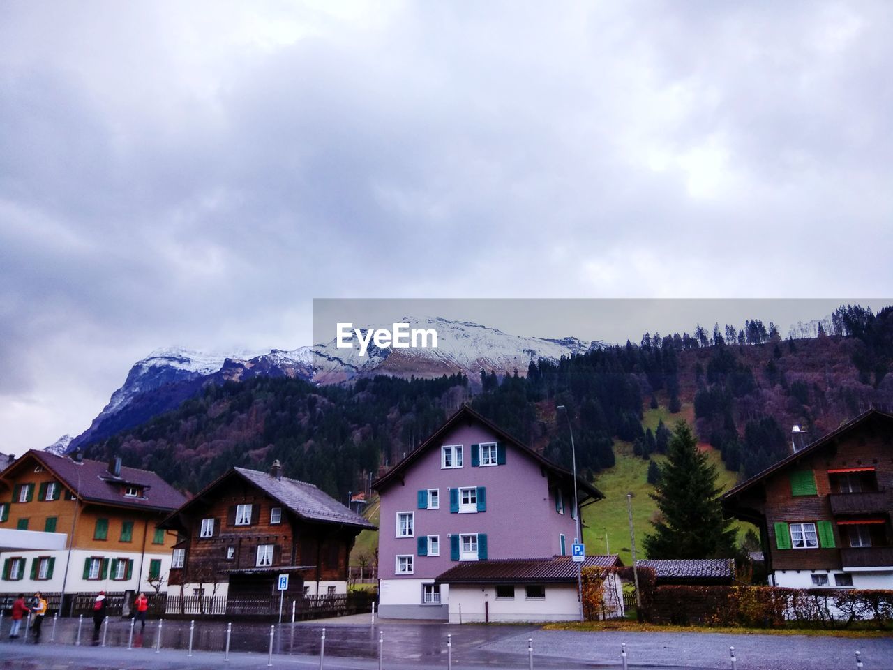 HOUSES AGAINST MOUNTAINS AGAINST SKY