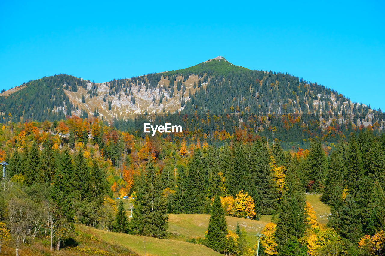 Scenic view of mountains against clear blue sky