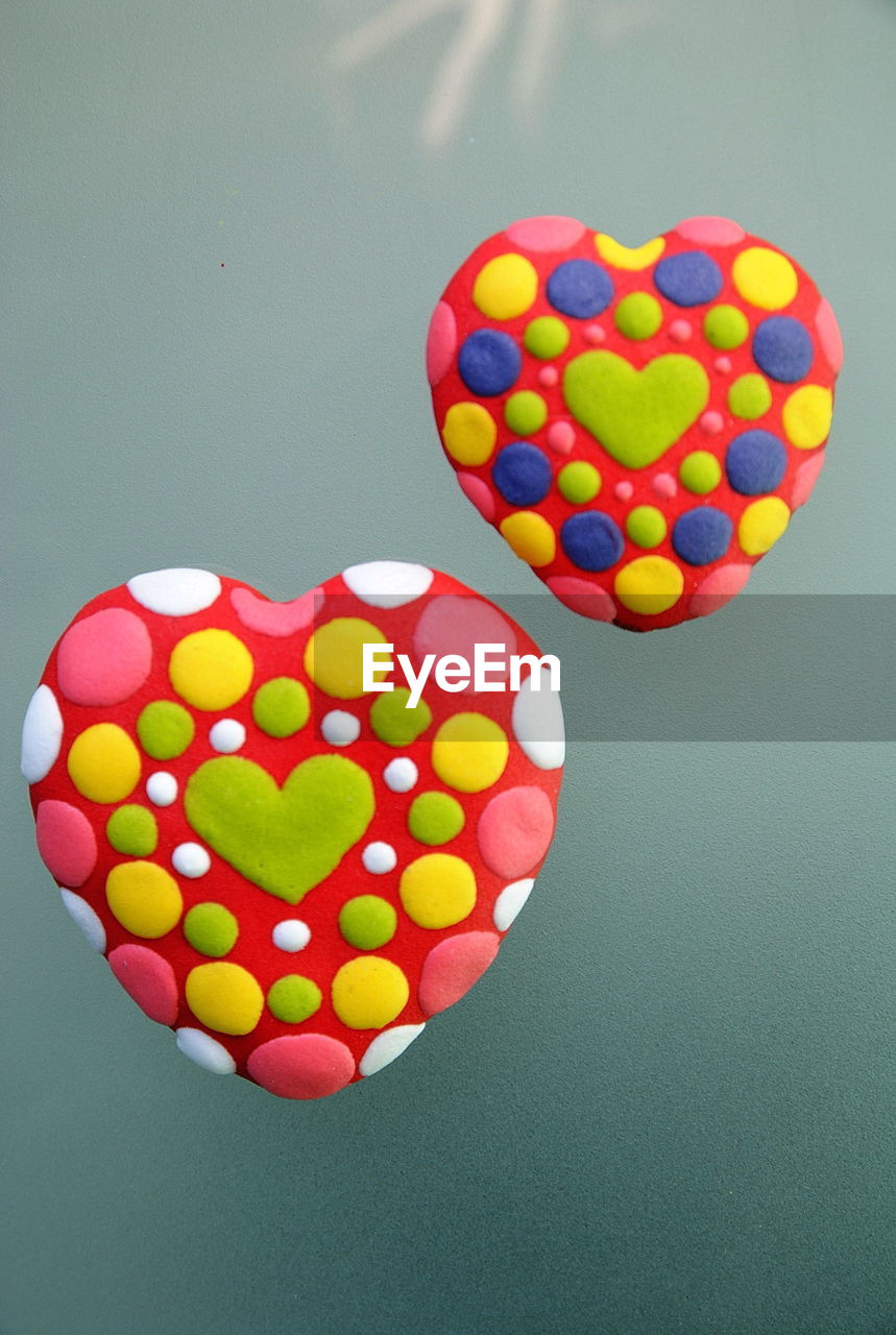CLOSE-UP OF HEART SHAPE MADE OF COLORFUL BALLOONS