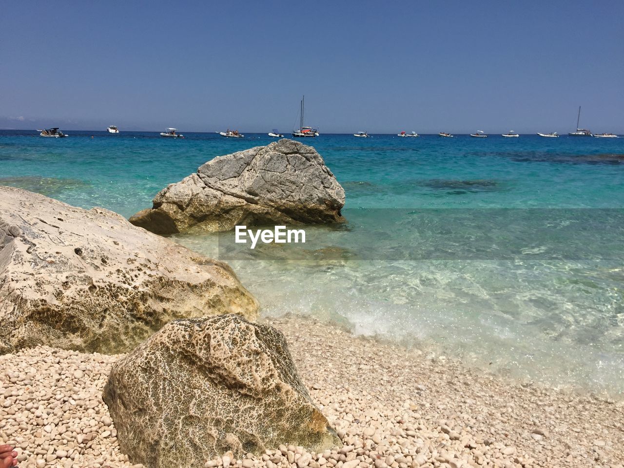 Scenic view of sea against clear blue sky