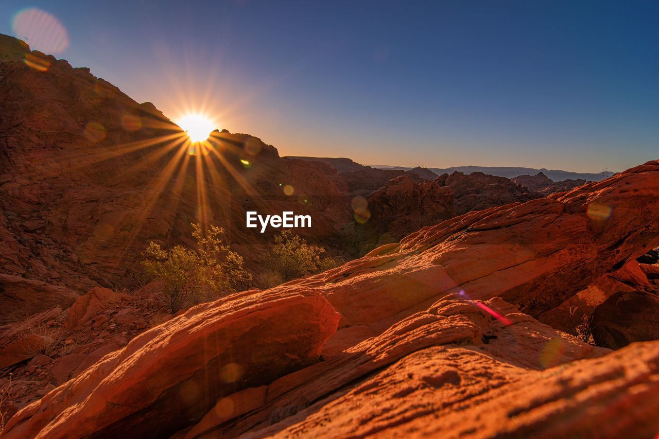 Scenic view of mountains against sky during sunset