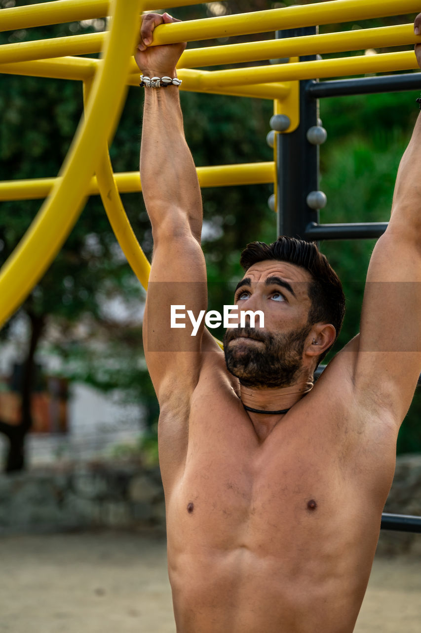 Close-up of young man wearing exercising outdoors