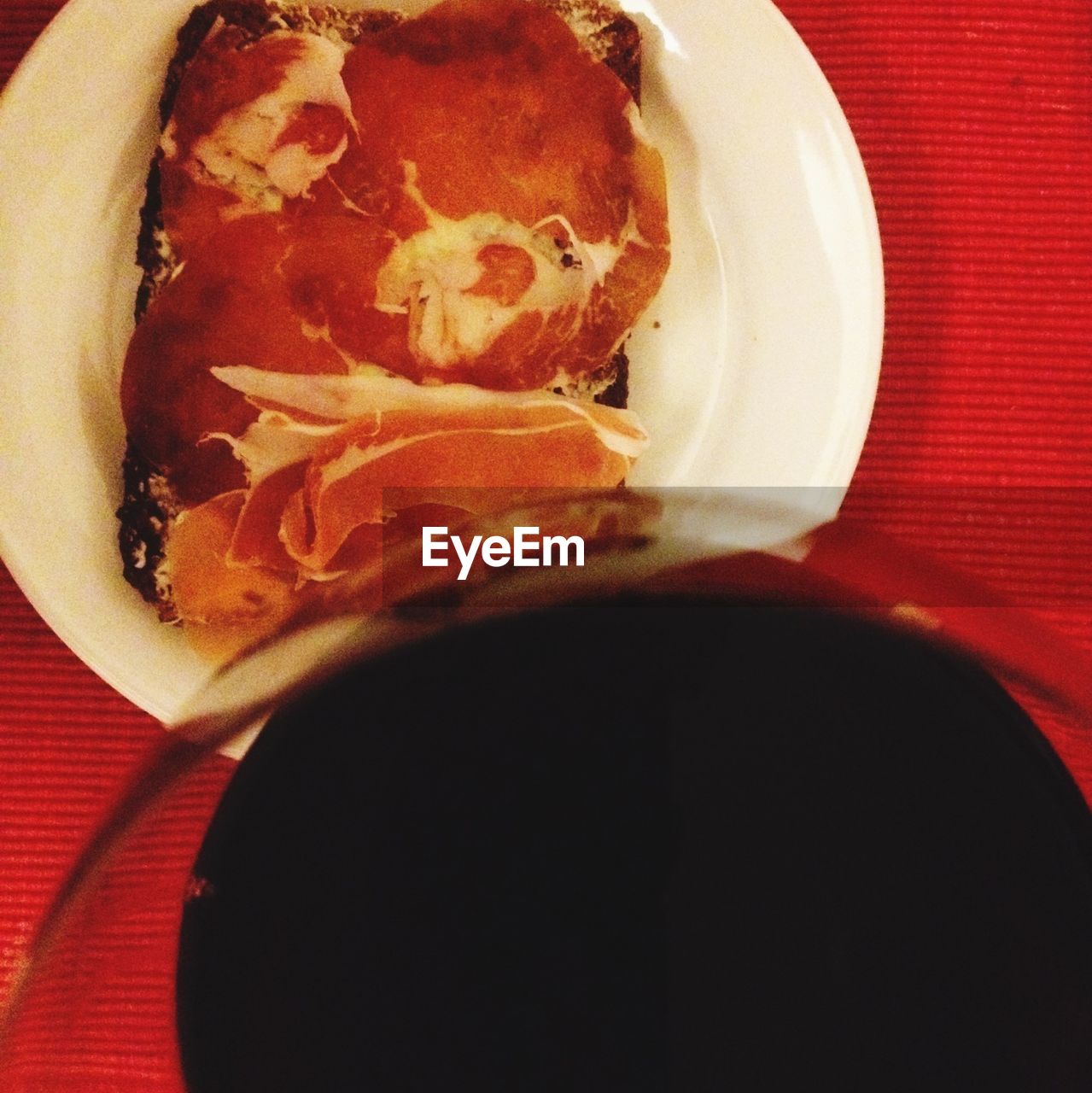 High angle view of drink with salami on bread at table