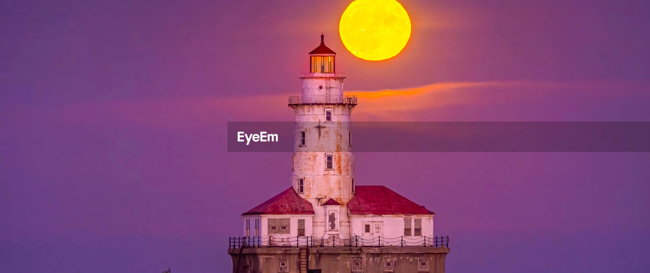 Lighthouse by sea against sky during sunset ,chicago city,usa