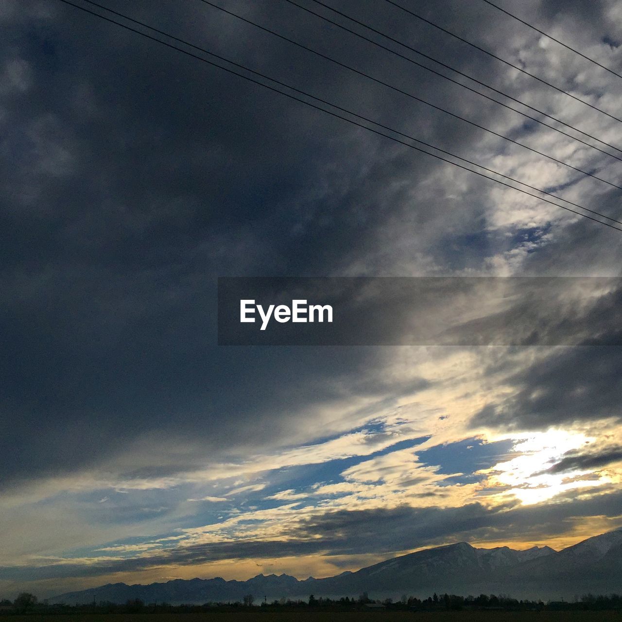 Low angle view of cloudy sky over mountains