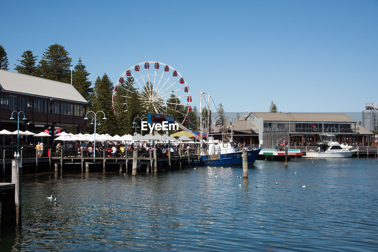 FERRIS WHEEL IN AMUSEMENT PARK AGAINST SKY