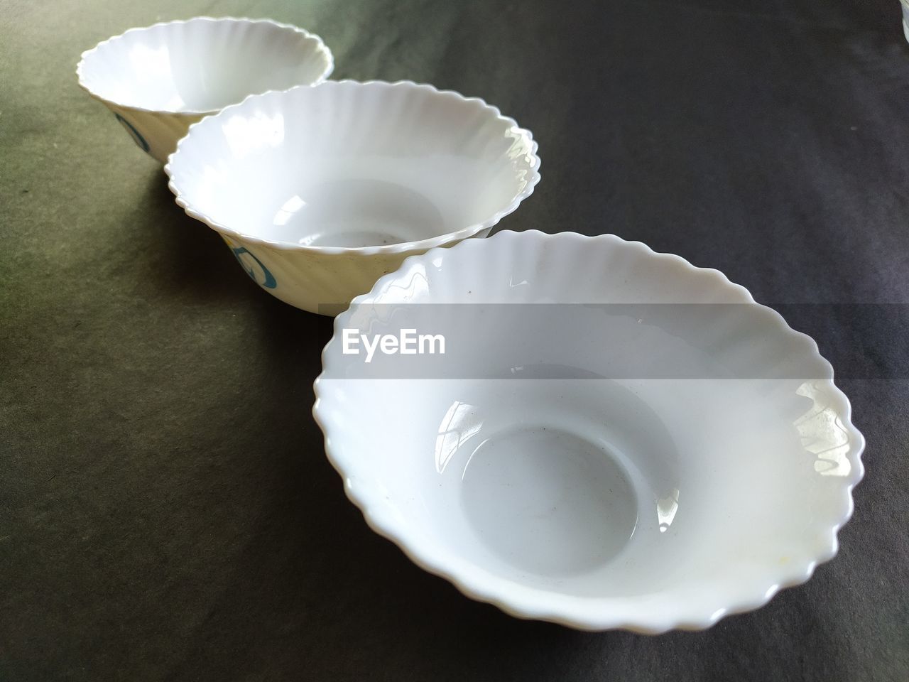 Top view white ceramic bowls, black background.