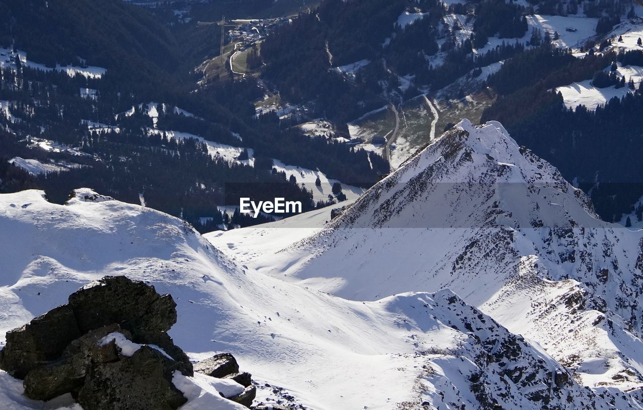 snow, cold temperature, winter, mountain, scenics - nature, mountain range, beauty in nature, environment, landscape, nature, ridge, snowcapped mountain, tranquility, no people, tranquil scene, day, non-urban scene, travel destinations, cirque, outdoors, white, ski mountaineering, travel, piste, sunlight, summit, sports, land, high angle view, idyllic, tourism
