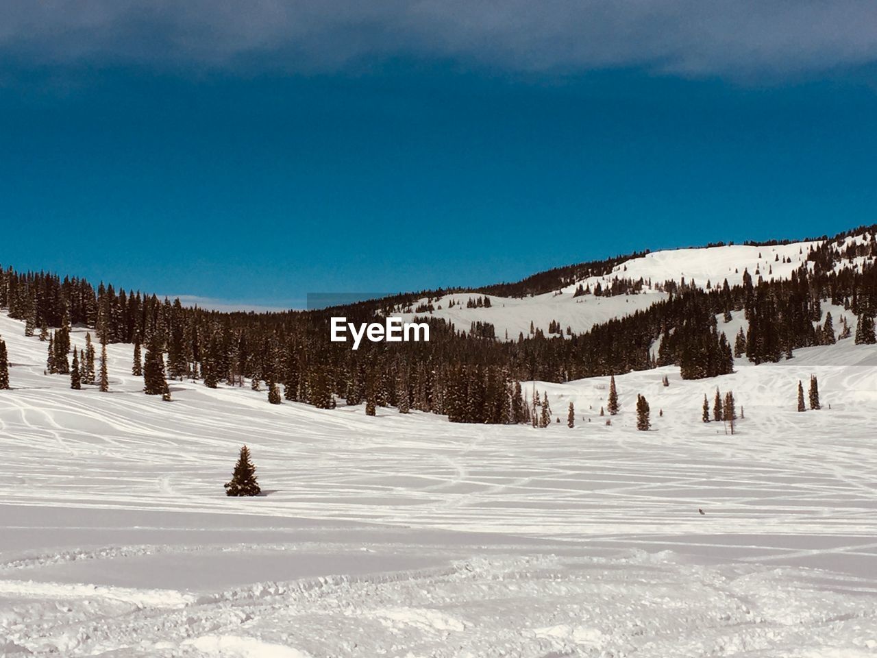 Scenic view of snow covered mountains against sky