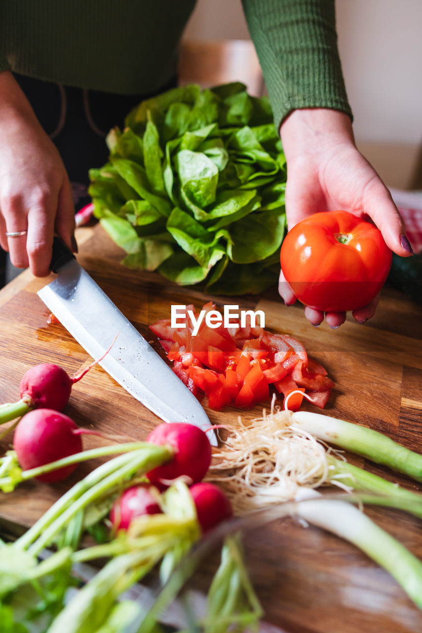 cropped hand of man preparing food on table