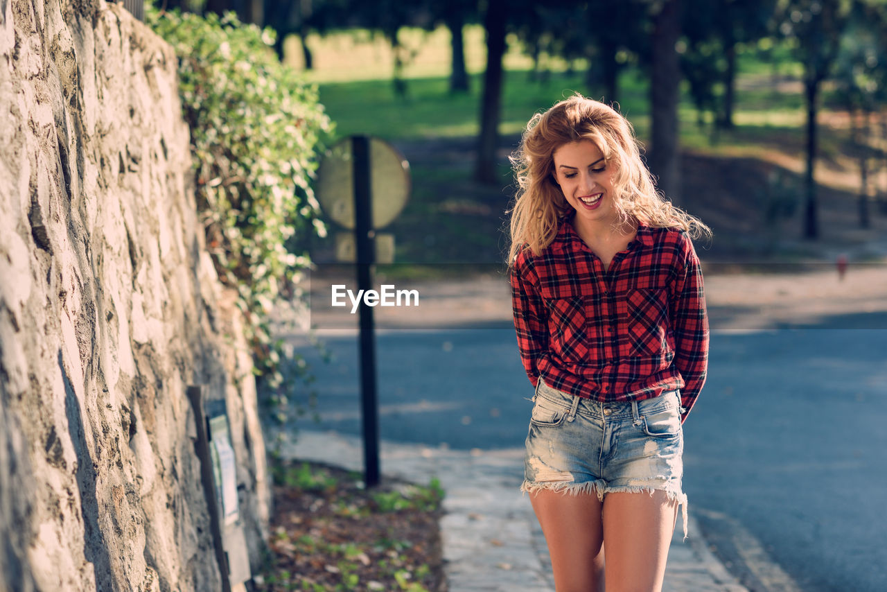 Young woman walking on footpath