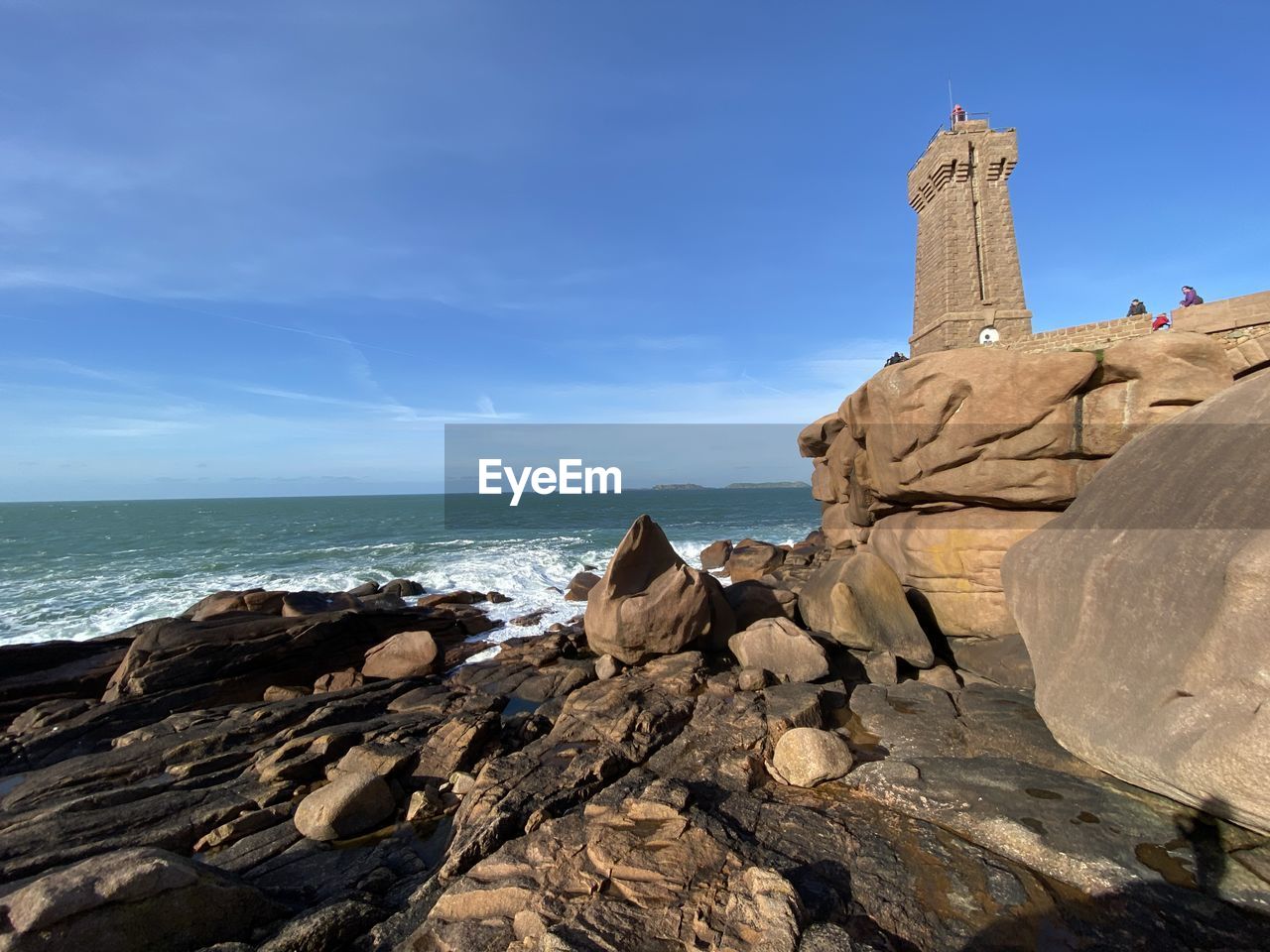 Rock formations on beach against sky