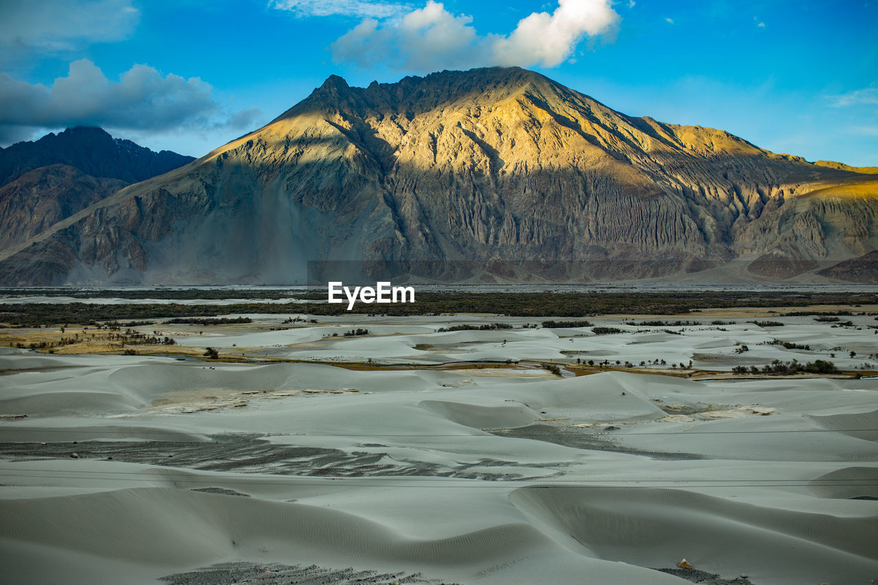 Scenic view of lake against cloudy sky