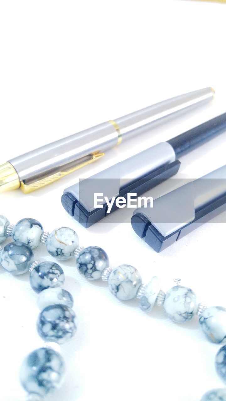 HIGH ANGLE VIEW OF OBJECTS ON WHITE TABLE