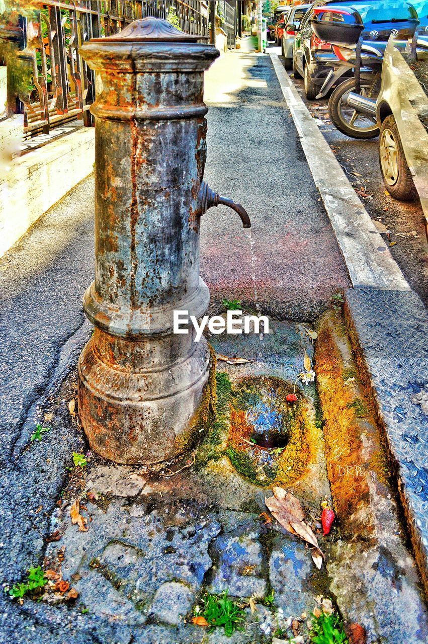 Abandoned fountain on sidewalk