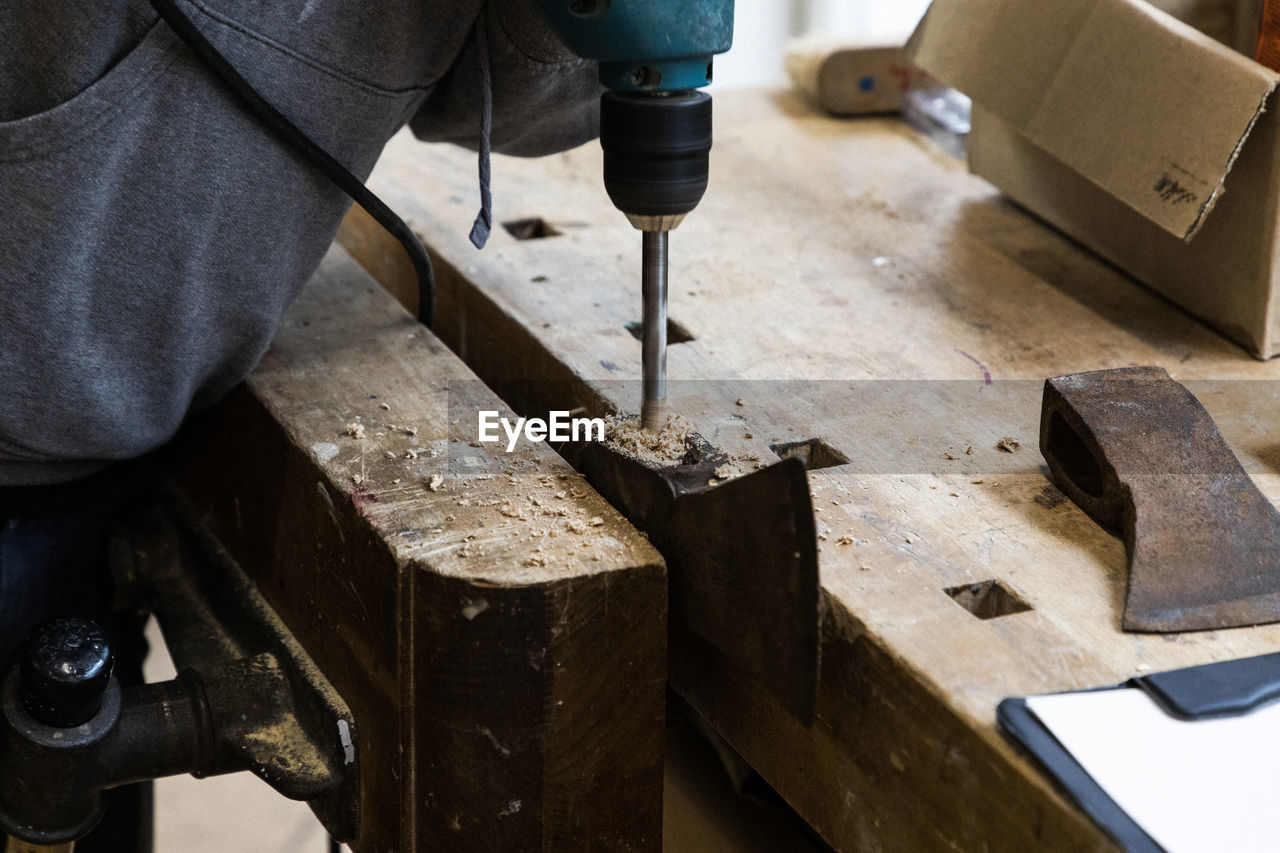 Close-up of drilling of an axe for restoration