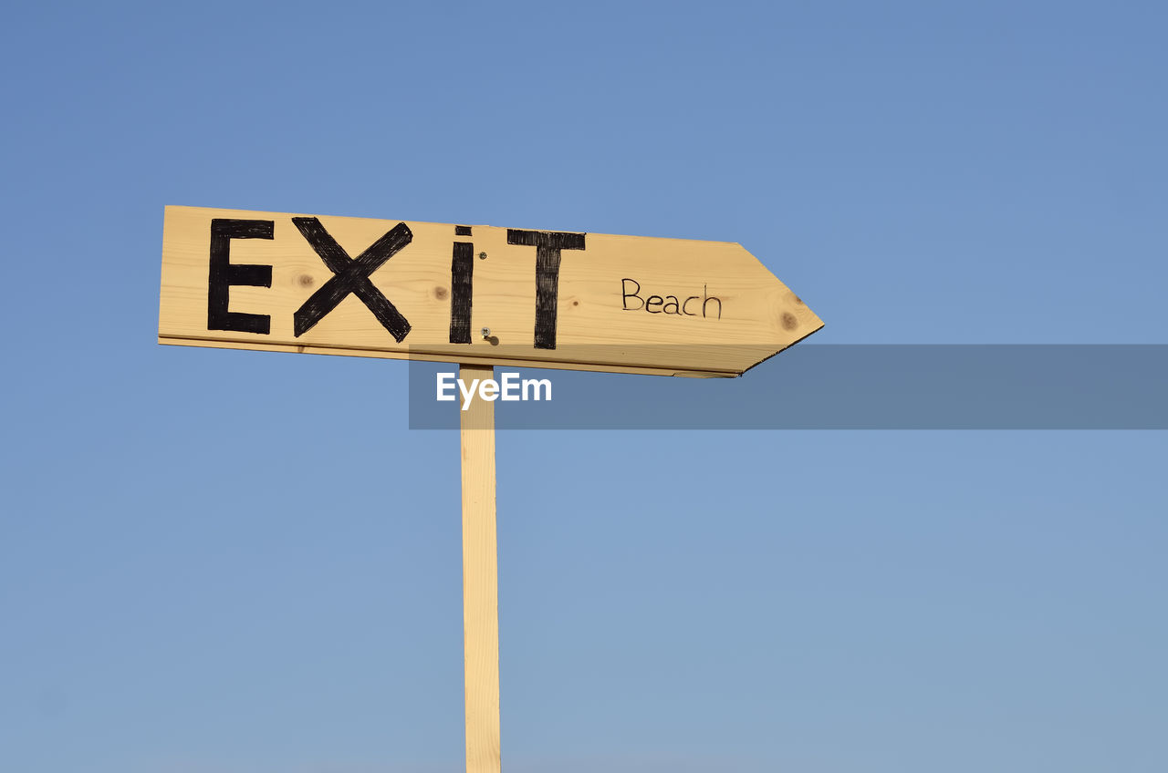 LOW ANGLE VIEW OF ROAD SIGN AGAINST BLUE SKY