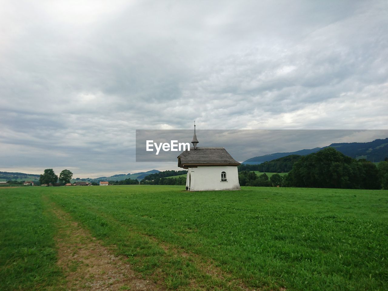 VIEW OF CROSS ON FIELD AGAINST SKY