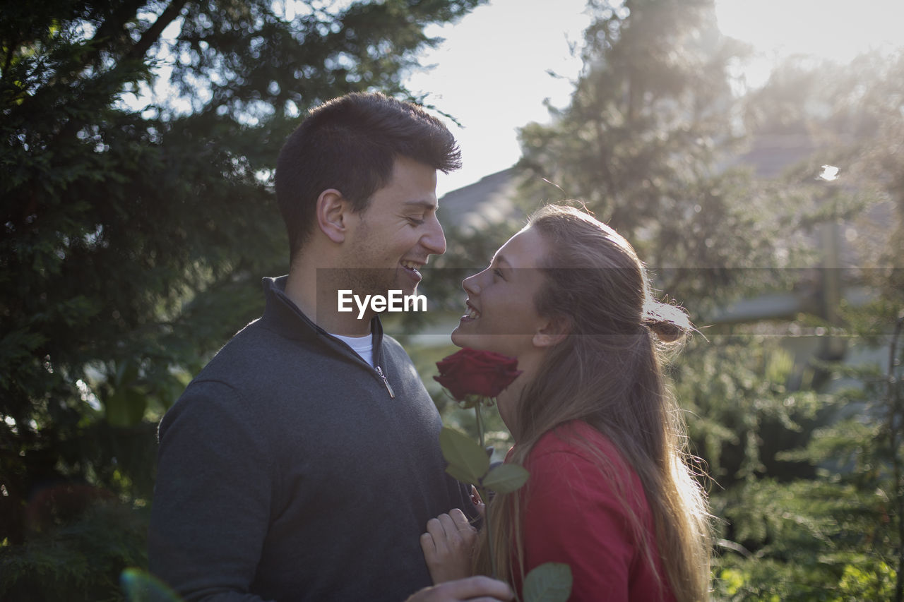 YOUNG COUPLE KISSING OUTDOORS