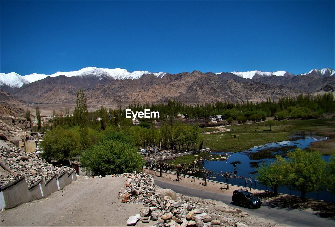 Scenic view of lake against clear blue sky