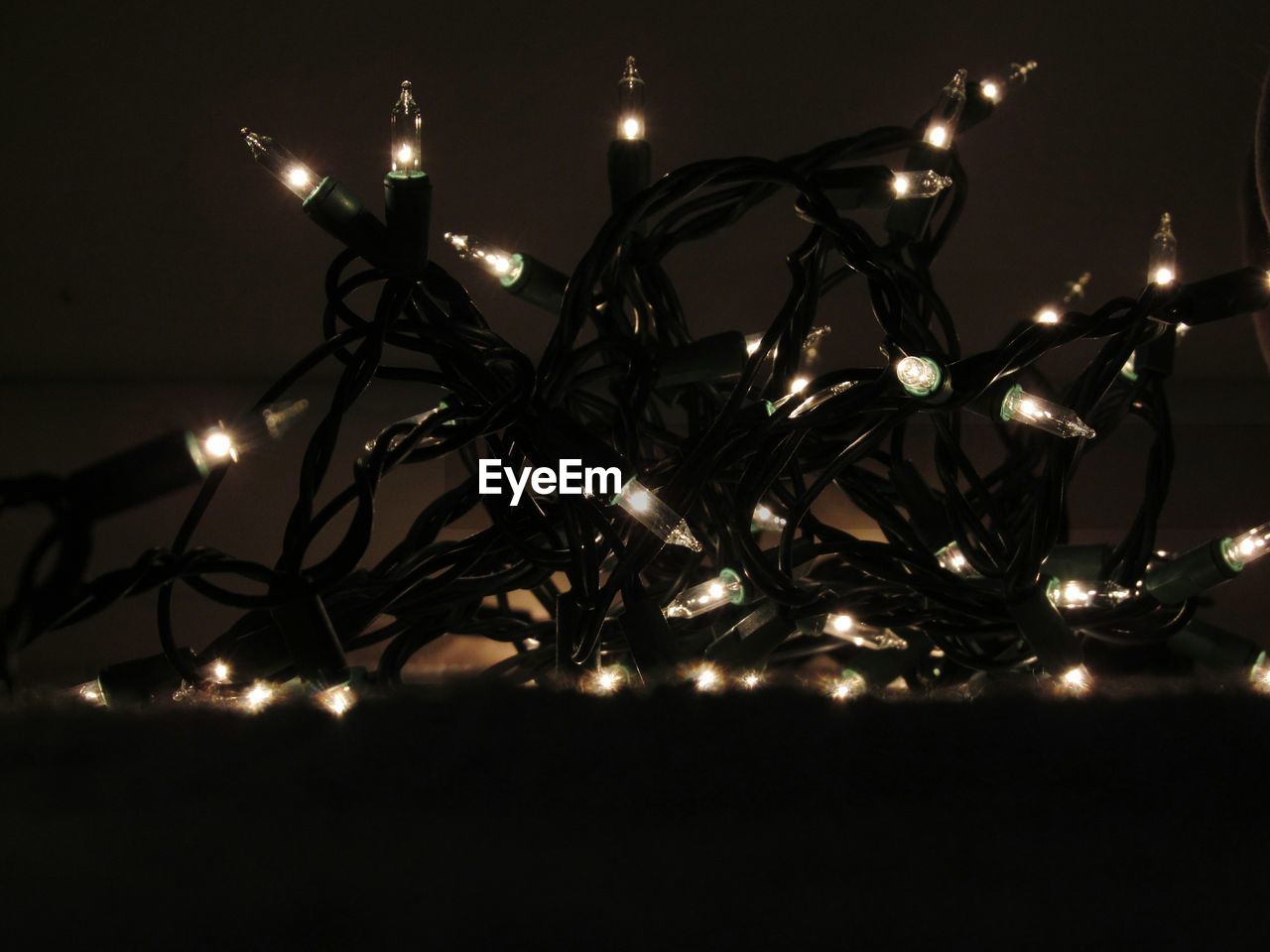 Close-up of illuminated fairy lights in dark