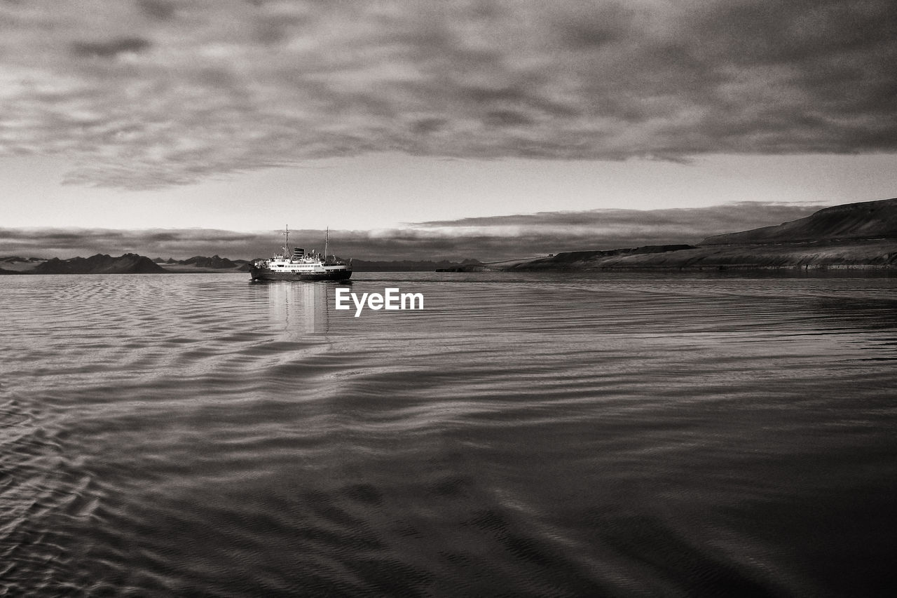 Scenic view of sea against sky, ship at svalbard coast