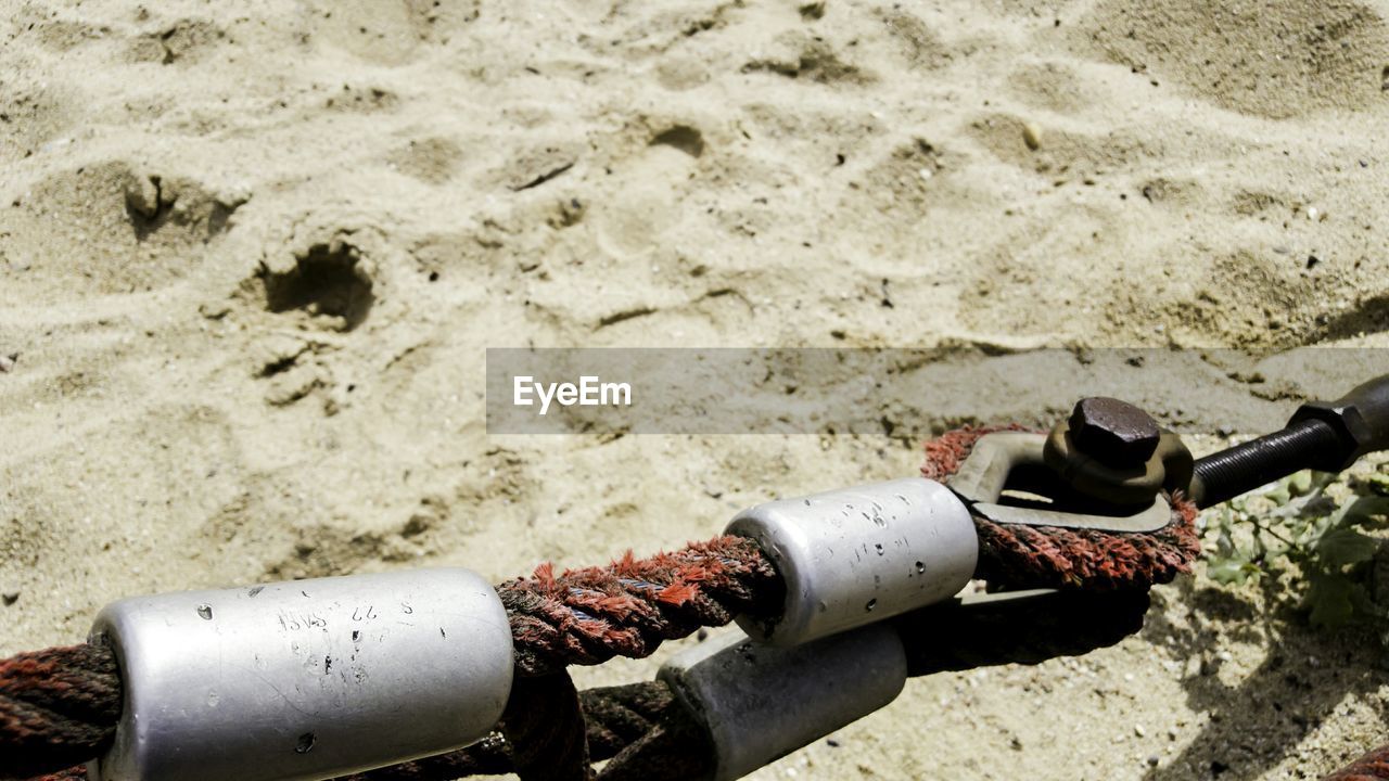 High angle view of rope above sandy beach during sunny day