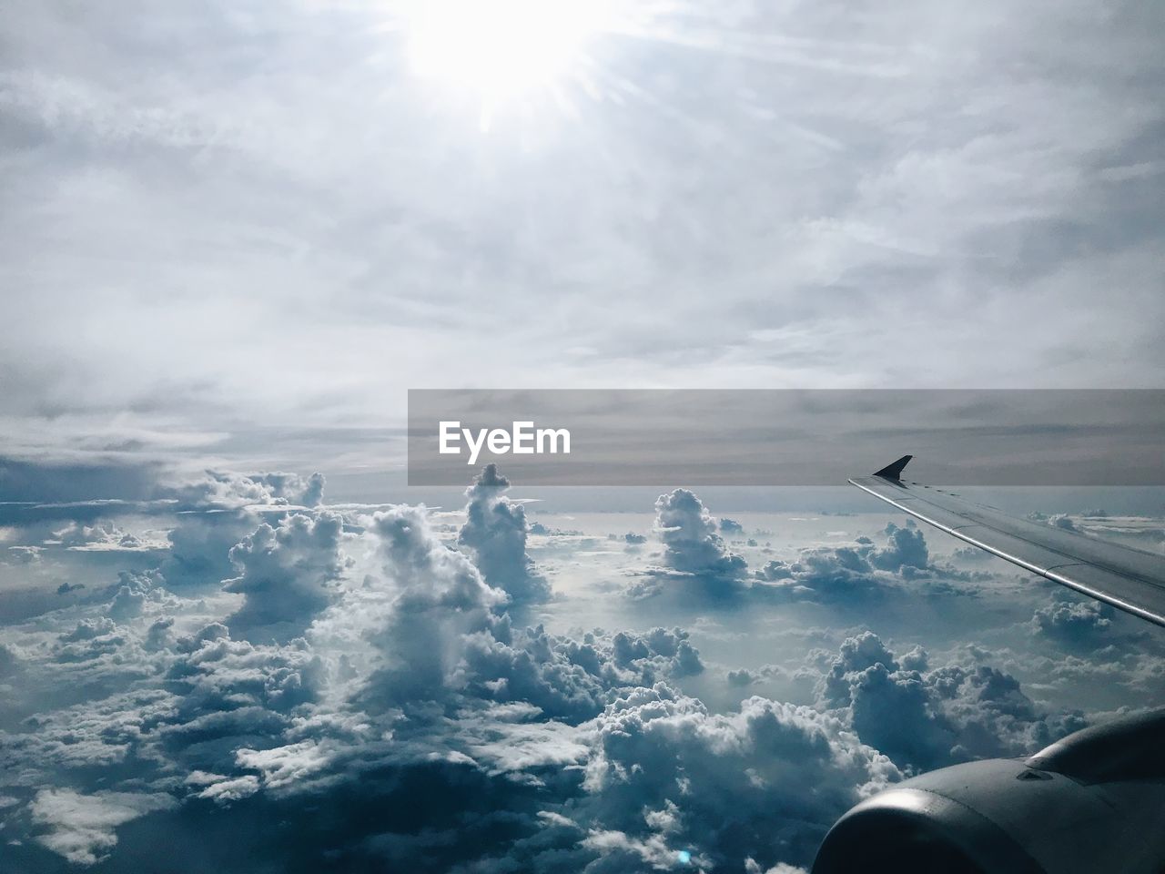 Airplane flying over cloudscape against sky