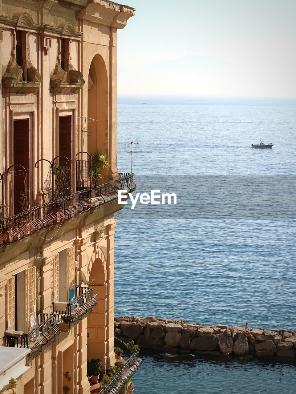 Building by sea against sky