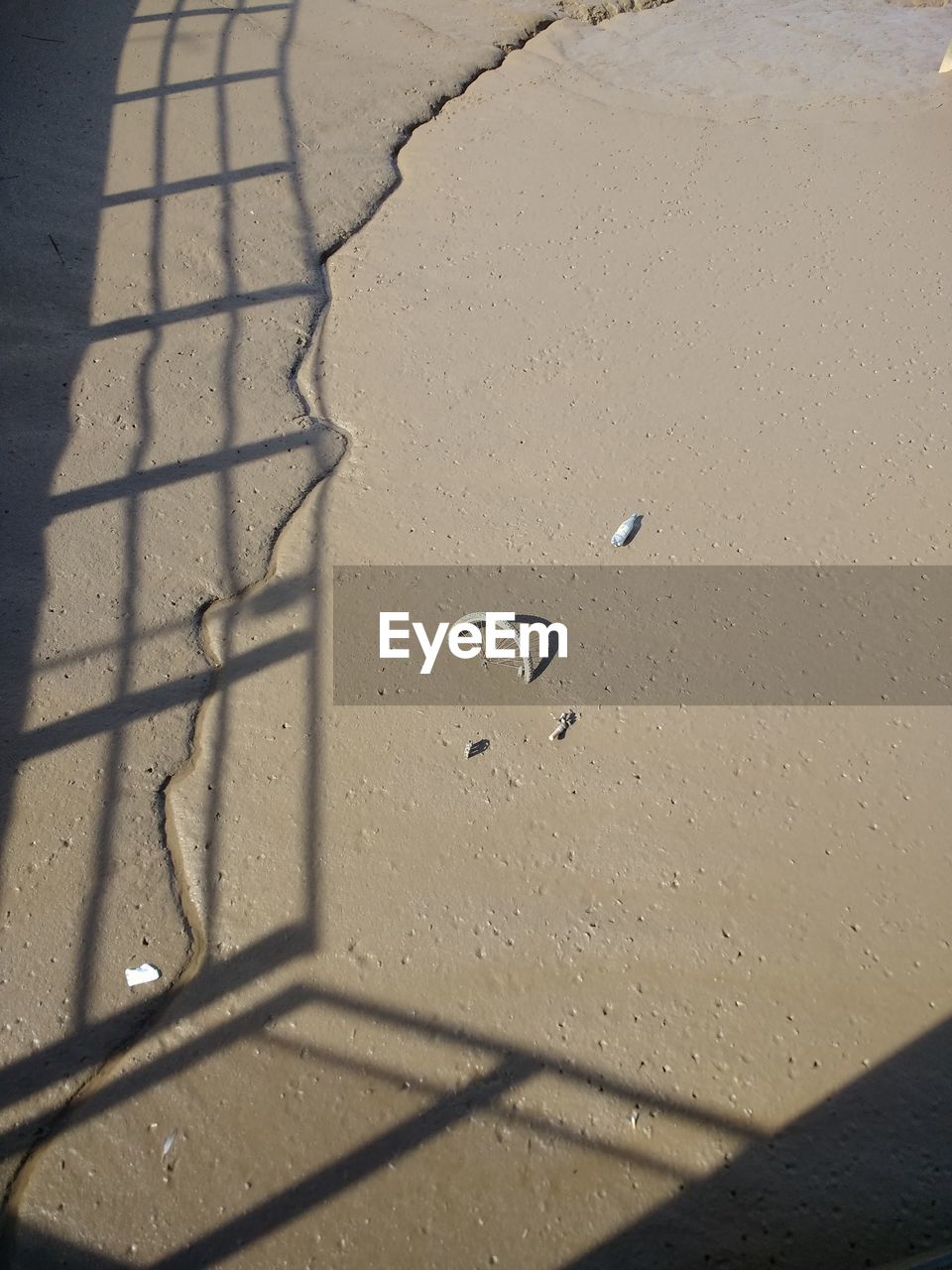 CLOSE-UP OF SHADOW ON SAND