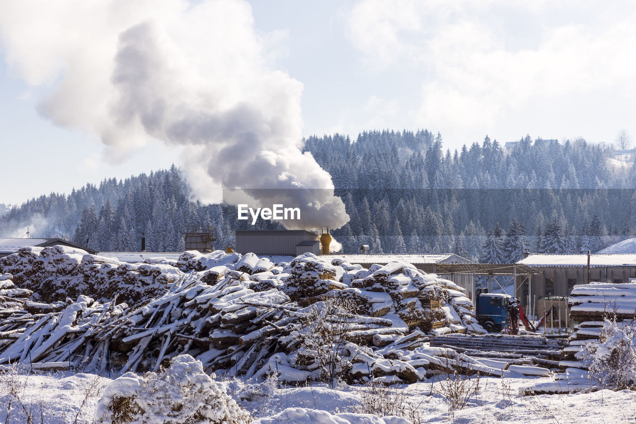 Air pollution smoke from factory chimney at rural nature in winter