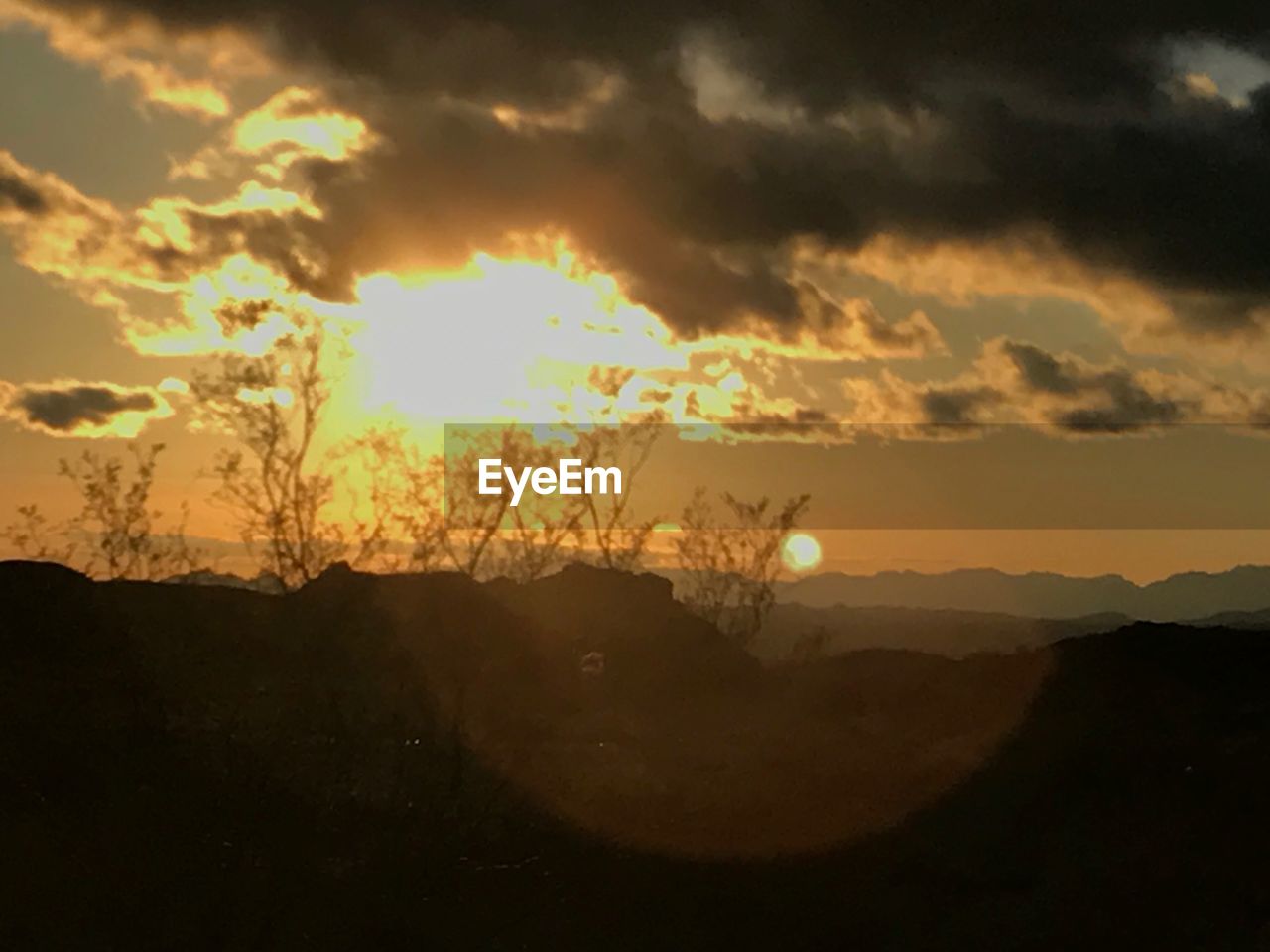 SCENIC VIEW OF SILHOUETTE LANDSCAPE AGAINST SKY AT SUNSET