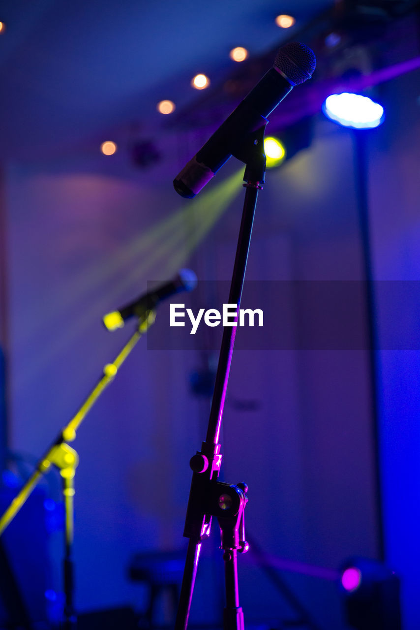 Close-up of microphones on stage