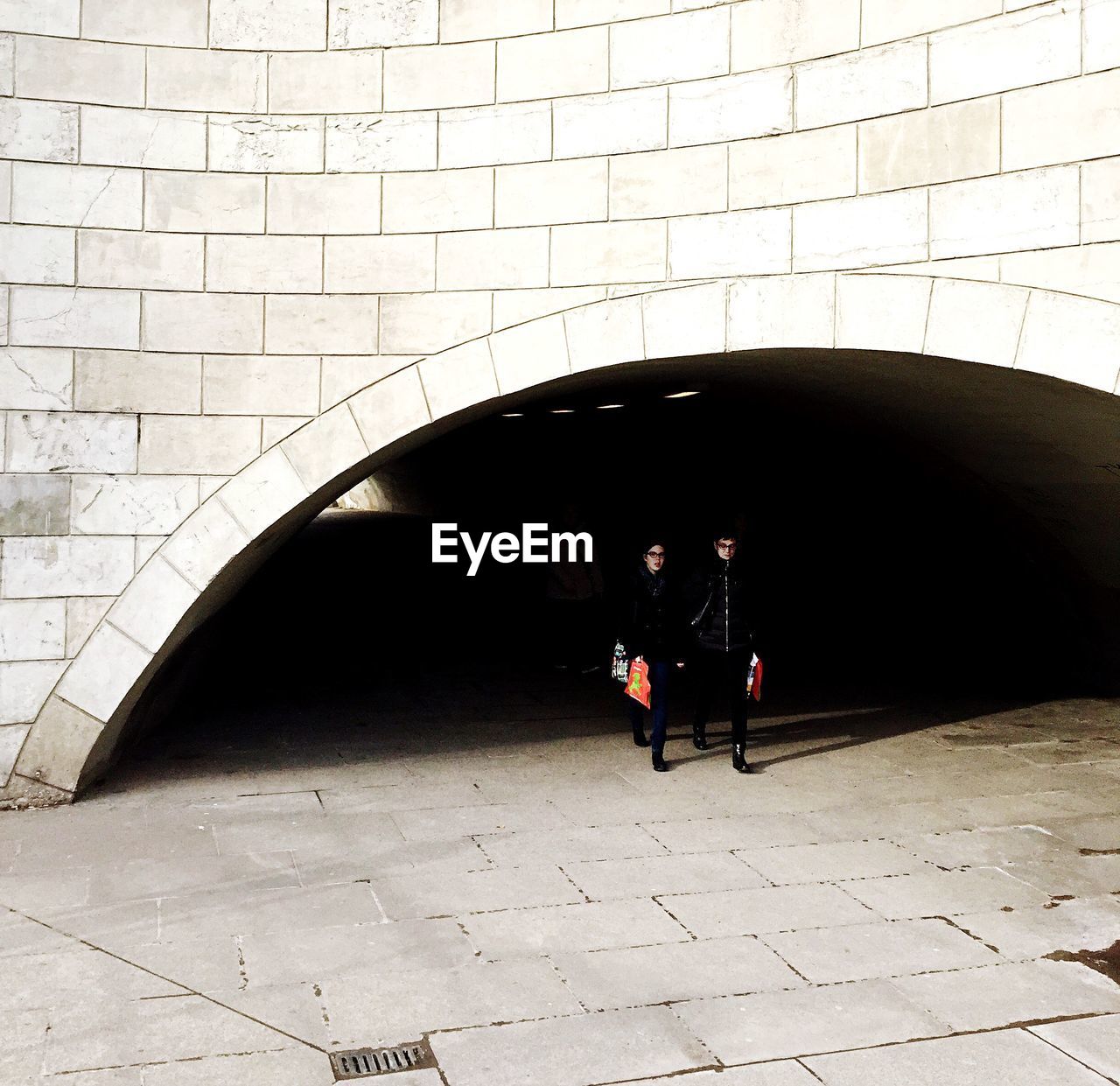 WOMAN WALKING IN TUNNEL