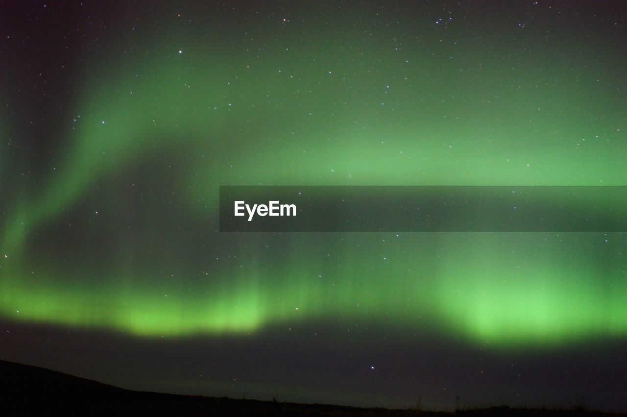 Scenic view of aurora borealis against sky at night