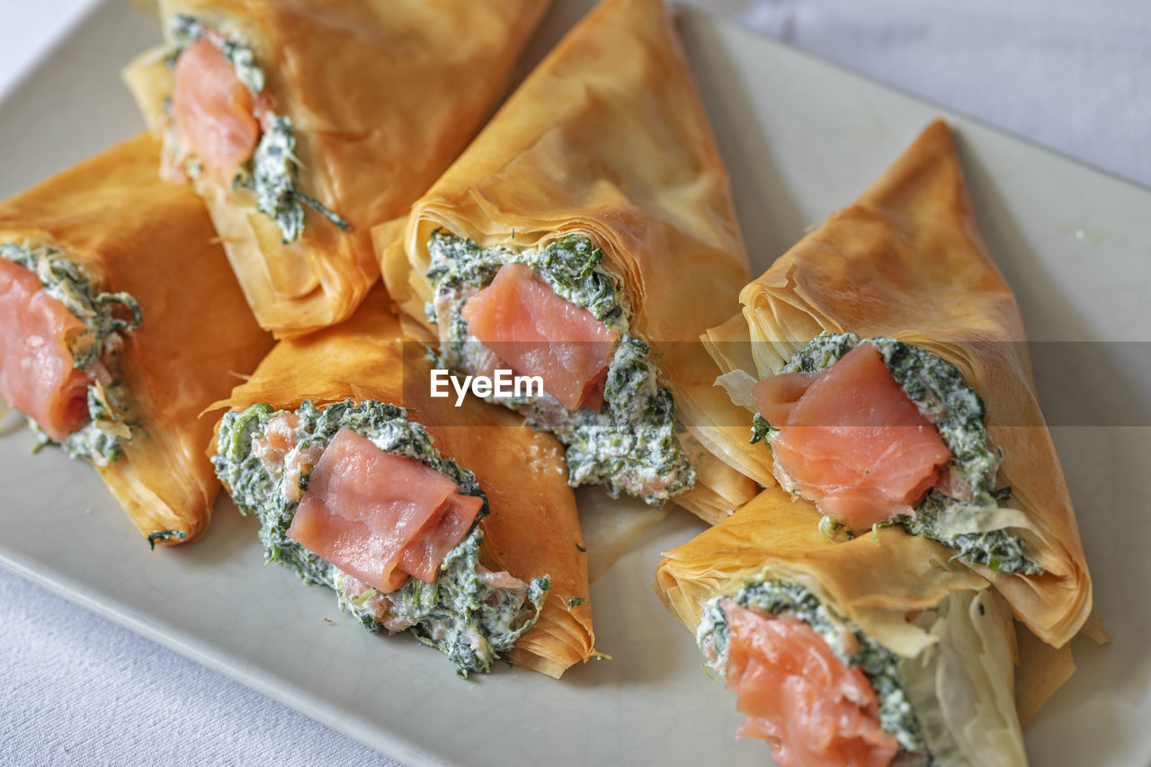 Filo dough cones stuffed with ricotta cheese, spinach and smoked salmon.