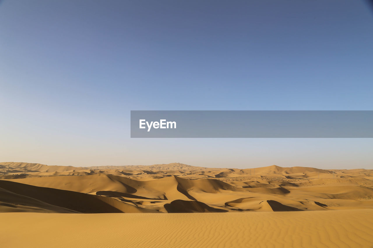 Scenic view of desert against clear sky