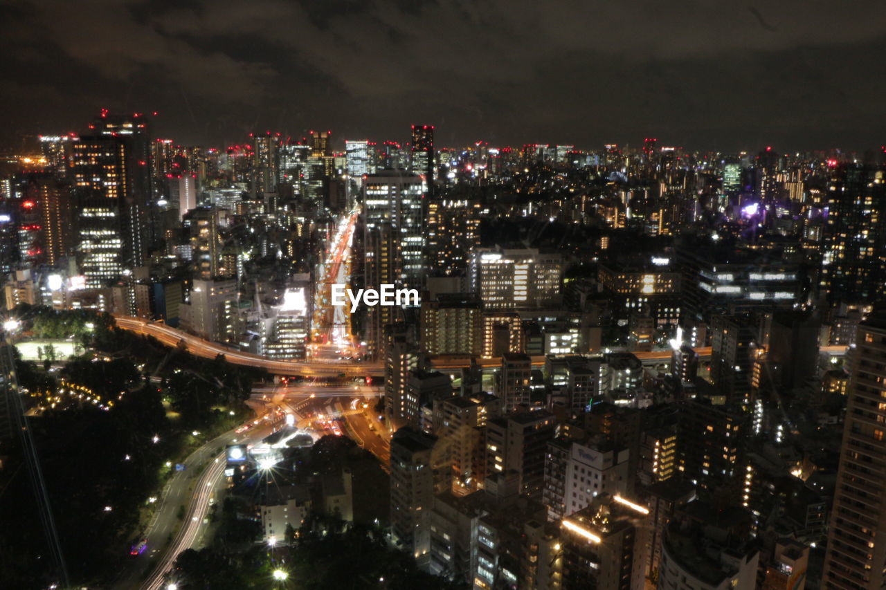 High angle view of illuminated city buildings at night