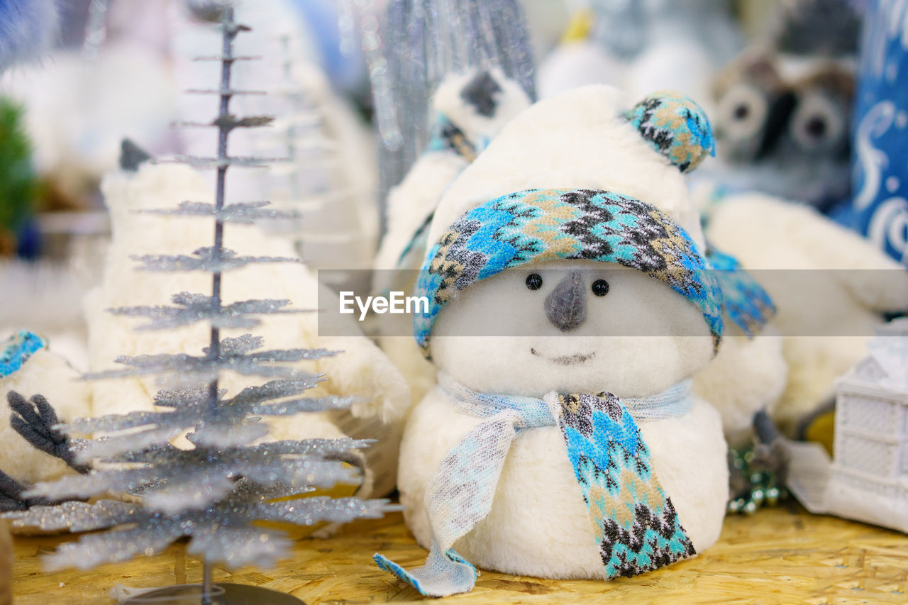 Christmas decoration toy white snowman made of cotton wool with a blue scarf, 