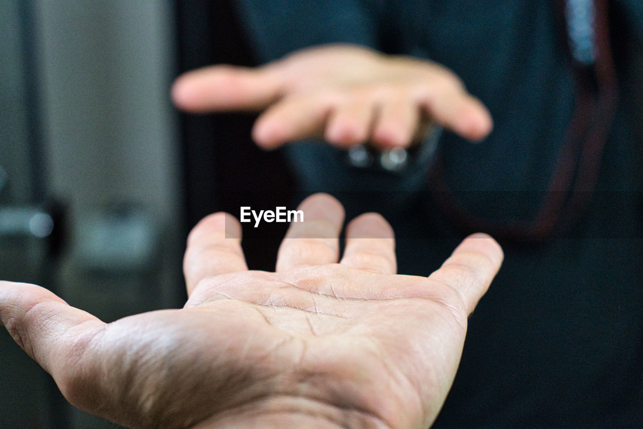 Cropped image of man reflecting while standing in front of mirror indoors