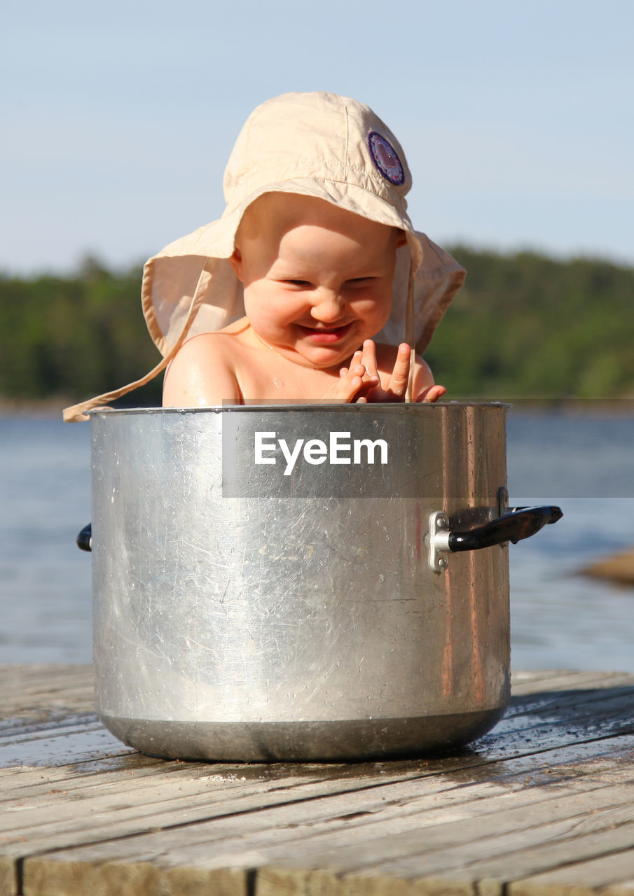 Cute girl sitting in pot 