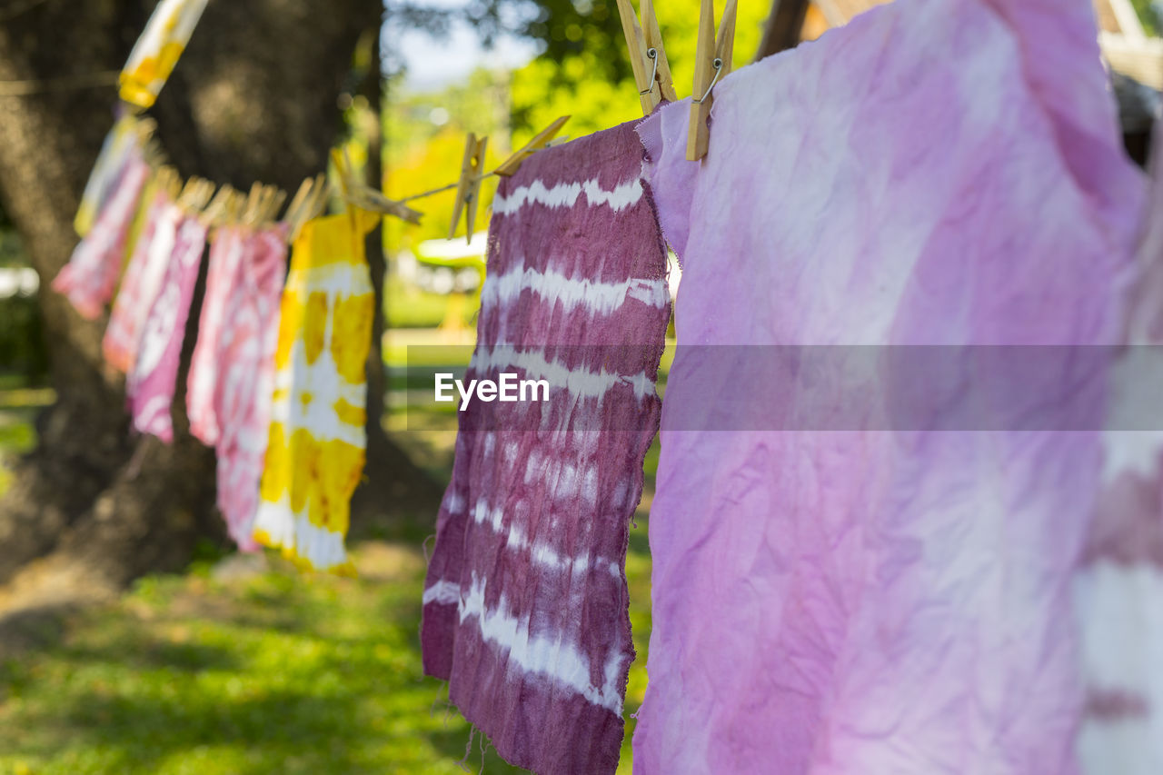 Colorful abstract tie dyed fabric hung up to dry.